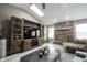 Spacious living room featuring vaulted ceilings, a brick fireplace, and modern entertainment center at 5782 Jamestown Square Ln, Indianapolis, IN 46234