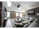 Bright living room with a brick fireplace, vaulted ceilings, and skylights for ample light at 5782 Jamestown Square Ln, Indianapolis, IN 46234