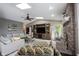 Open concept living room with vaulted ceilings, a brick fireplace, and comfortable seating arrangement at 5782 Jamestown Square Ln, Indianapolis, IN 46234
