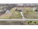 Expansive aerial view showcasing the home's setting on a large lot, surrounded by mature trees and open fields at 5802 Watson Rd, Greenwood, IN 46143