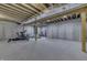 Unfinished basement area with concrete walls and floor, exposed ceiling, and workout equipment at 5802 Watson Rd, Greenwood, IN 46143