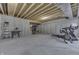 Spacious unfinished basement featuring concrete floors, open ceiling, and workout equipment at 5802 Watson Rd, Greenwood, IN 46143