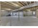 Unfinished basement with concrete walls and floor, exposed wood ceiling, and utility connections at 5802 Watson Rd, Greenwood, IN 46143
