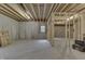 Unfinished basement with concrete walls and floor, exposed wood ceiling, and window at 5802 Watson Rd, Greenwood, IN 46143