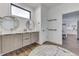 Bright bathroom featuring double sinks, a storage cabinet and door to walk-in closet at 5802 Watson Rd, Greenwood, IN 46143