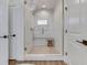 Luxurious primary bathroom showcases a frameless shower with dual shower heads and marble-look tile at 5802 Watson Rd, Greenwood, IN 46143