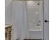 Bathroom with shower/tub, accented by neutral colored floor tiles and white shower curtain at 5802 Watson Rd, Greenwood, IN 46143
