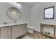 This bathroom has modern vanity, round mirror, gold fixtures, and a window for natural light at 5802 Watson Rd, Greenwood, IN 46143