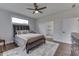 Light-filled bedroom with a dark wood bed frame and door leading to the bathroom at 5802 Watson Rd, Greenwood, IN 46143