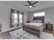 Comfortable bedroom with a dark wood bed frame, ceiling fan, and plenty of natural light at 5802 Watson Rd, Greenwood, IN 46143