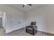 Bright bedroom with ceiling fan, featuring a comfortable recliner and double closets at 5802 Watson Rd, Greenwood, IN 46143