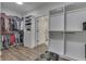 Generous walk-in closet features custom shelving and drawers with an ottoman for seating at 5802 Watson Rd, Greenwood, IN 46143