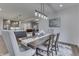 Open-concept dining area with a wooden table, elegant chairs, and a view into the living room at 5802 Watson Rd, Greenwood, IN 46143