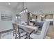 Well-lit dining room with a wood table, neutral chairs, and seamless access to the kitchen area at 5802 Watson Rd, Greenwood, IN 46143