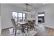 Elegant dining room featuring a wooden table, stylish chairs, and a large window with a scenic view at 5802 Watson Rd, Greenwood, IN 46143