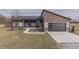 Charming modern home with a welcoming front porch, attached garage, and well-manicured lawn at 5802 Watson Rd, Greenwood, IN 46143