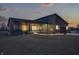 Well-lit, charming single story home exterior with modern garage door and landscaped front yard at twilight at 5802 Watson Rd, Greenwood, IN 46143