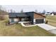 Stunning exterior view of a modern, single story home with a two-car garage and a spacious front yard at 5802 Watson Rd, Greenwood, IN 46143