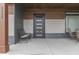 Inviting front porch featuring stylish seating, a modern front door with glass panels, and sleek architectural details at 5802 Watson Rd, Greenwood, IN 46143