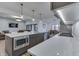 Modern kitchen featuring a quartz countertop island, stainless steel appliances, and open floor plan at 5802 Watson Rd, Greenwood, IN 46143