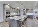 Modern kitchen featuring stainless steel appliances, a spacious island with seating, and pendant lighting at 5802 Watson Rd, Greenwood, IN 46143