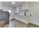 Bright laundry room featuring front load washer and dryer, white cabinets, and a sink at 5802 Watson Rd, Greenwood, IN 46143