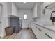 The laundry room has gray front load washer and dryer with white cabinets and plenty of counter space at 5802 Watson Rd, Greenwood, IN 46143