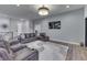 Stylish living room with modern furniture, a soft rug, and an open view to the entryway and other living areas at 5802 Watson Rd, Greenwood, IN 46143