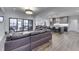 Open-concept living room with hardwood floors, a large sliding glass door to the patio, and modern kitchen at 5802 Watson Rd, Greenwood, IN 46143