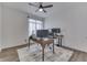 Office with ceiling fan, featuring a work space with a large window and a modern desk at 5802 Watson Rd, Greenwood, IN 46143