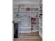 Walk-in pantry with custom shelving, wood floor, beverage fridge, and ample storage space at 5802 Watson Rd, Greenwood, IN 46143