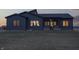 This single story home's back has dark siding, screen porch, lots of windows, and large backyard at 5802 Watson Rd, Greenwood, IN 46143