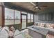 Relaxing screened-in porch featuring comfortable seating, fire pit, and scenic backyard views at 5802 Watson Rd, Greenwood, IN 46143