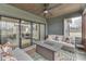 Cozy screened porch with plush seating, outdoor fireplace, and sliding glass doors to the outdoors at 5802 Watson Rd, Greenwood, IN 46143