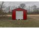 Red storage shed with roll up door in a large yard with room for outdoor activities or expanding your garden at 5802 Watson Rd, Greenwood, IN 46143