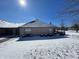Exterior of the backyard of the house with brick and snow covering the yard at 5850 Bradston Way, Indianapolis, IN 46237