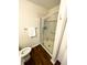 This bathroom features a toilet and a shower with sliding glass doors and neutral tile surround at 5850 Bradston Way, Indianapolis, IN 46237