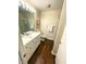 Bathroom vanity with white cabinets, wood floor and mirror with Hollywood style lighting at 5850 Bradston Way, Indianapolis, IN 46237