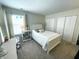 Neutral bedroom with white trimmings, neutral carpet, white bed and two closets at 5850 Bradston Way, Indianapolis, IN 46237