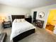 This bedroom has a bed with white linens, a dresser, and a closet with sliding doors at 5850 Bradston Way, Indianapolis, IN 46237