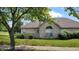 Charming brick home featuring a well-maintained lawn and mature trees, creating a welcoming curb appeal at 5850 Bradston Way, Indianapolis, IN 46237