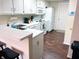 Well-lit kitchen featuring modern appliances, white cabinetry, and a breakfast bar at 5850 Bradston Way, Indianapolis, IN 46237