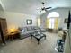Cozy living room featuring a fireplace, ceiling fan, and comfortable grey couch at 5850 Bradston Way, Indianapolis, IN 46237