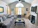 Bright living room with vaulted ceilings, a fireplace, and comfortable seating at 5850 Bradston Way, Indianapolis, IN 46237