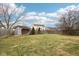 Large grassy backyard with shed and privacy fence at 6354 River Run Dr, Indianapolis, IN 46221