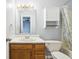 Bathroom with wood vanity, linen cabinet and tub at 6354 River Run Dr, Indianapolis, IN 46221