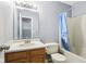 Clean bathroom with a shower/tub combo and wood vanity at 6354 River Run Dr, Indianapolis, IN 46221