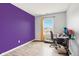 Bright bedroom with a workspace and purple accent wall at 6354 River Run Dr, Indianapolis, IN 46221