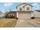 Two-story house with beige siding, red brick, and a two-car garage at 6354 River Run Dr, Indianapolis, IN 46221