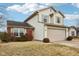 Two-story house with beige siding, red brick, and a two-car garage at 6354 River Run Dr, Indianapolis, IN 46221